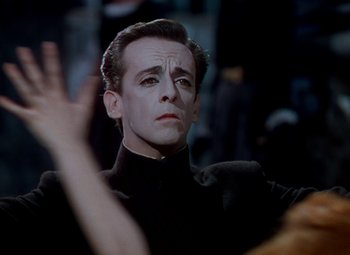 Movie still from “The Red Shoes” (1948), directed by Michael Powell – A person wearing a suit and tie; Close Up shot, Low angle