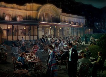 Movie still from “The Red Shoes” (1948), directed by Michael Powell – A painting of people sitting at tables outside a restaurant; Extreme Wide shot, High angle