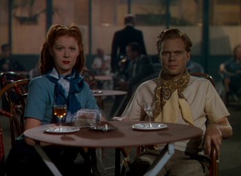 Movie still from “The Red Shoes” (1948), directed by Michael Powell – A man and a woman sitting at a table in a restaurant; Medium shot, Low angle