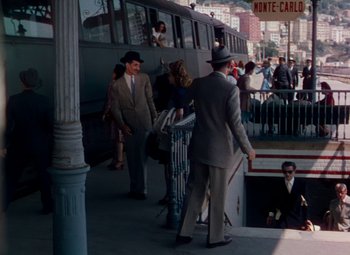 Movie still from “The Red Shoes” (1948), directed by Michael Powell – A group of people standing on the side of a train; Wide shot, High angle