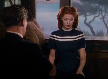 Movie still from “The Red Shoes” (1948), directed by Michael Powell – A man and a woman are standing in front of a window; Medium shot, Over the shoulder angle