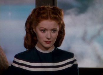 Movie still from “The Red Shoes” (1948), directed by Michael Powell – A woman with red hair wearing a black and white striped sweater; Close Up shot, High angle