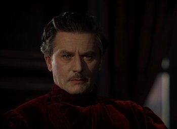 Movie still from “The Red Shoes” (1948), directed by Michael Powell – A person wearing a suit and tie; Close Up shot, Low angle