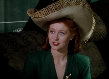Movie still from “The Red Shoes” (1948), directed by Michael Powell – A woman in a green dress wearing a hat; Close Up shot, Low angle