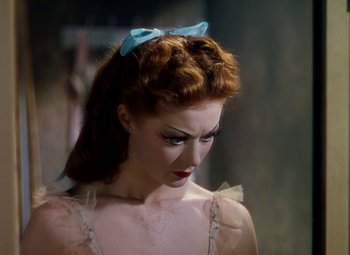 Movie still from “The Red Shoes” (1948), directed by Michael Powell – A person wearing a dress with a bow; Close Up shot, High angle