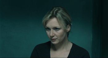 Movie still from “The Return” (2003), directed by Andrey Zvyagintsev – A woman in a black shirt is looking to her left; Close Up shot, High angle