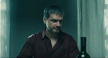 Movie still from “The Return” (2003), directed by Andrey Zvyagintsev – A person sitting at a table; Close Up shot, Over the shoulder angle