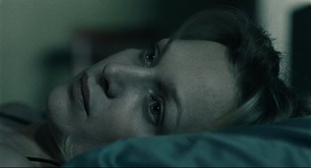 Movie still from “The Return” (2003), directed by Andrey Zvyagintsev – A woman laying in a bed with her eyes open; Close Up shot, Overhead angle