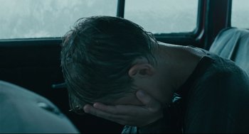 Movie still from “The Return” (2003), directed by Andrey Zvyagintsev – A person with their head in their hands; Close Up shot, Over the shoulder angle