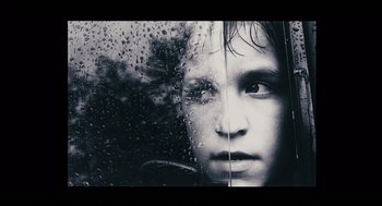 Movie still from “The Return” (2003), directed by Andrey Zvyagintsev – A young girl looking out of a car window; Extreme Close Up shot, Low angle