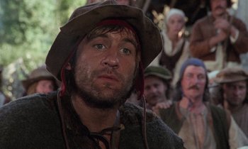Movie still from “The Return of Martin Guerre” (1982), directed by Daniel Vigne – A person wearing a hat with a bunch of people in the background; Close Up shot, Low angle