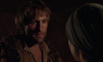Movie still from “The Return of Martin Guerre” (1982), directed by Daniel Vigne – A man looking into a mirror while standing next to a woman; Close Up shot, Over the shoulder angle