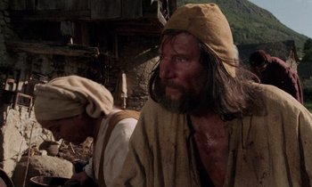 Movie still from “The Return of Martin Guerre” (1982), directed by Daniel Vigne – A man with long hair and a beard wearing a hat; Medium shot, Low angle