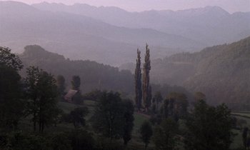 Movie still from “The Return of Martin Guerre” (1982), directed by Daniel Vigne – A view of a valley with trees in the foreground; Extreme Wide shot, High angle