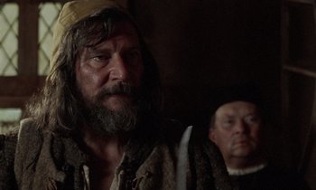 Movie still from “The Return of Martin Guerre” (1982), directed by Daniel Vigne – A man with long hair and a beard and a man with long hair and a beard; Close Up shot, Over the shoulder angle