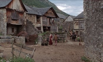 Movie still from “The Return of Martin Guerre” (1982), directed by Daniel Vigne – A group of people walking in a dirt field; Extreme Wide shot, High angle