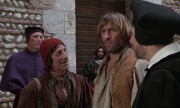 Movie still from “The Return of Martin Guerre” (1982), directed by Daniel Vigne – A group of men standing next to each other; Medium shot, Over the shoulder angle