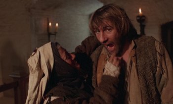 Movie still from “The Return of Martin Guerre” (1982), directed by Daniel Vigne – A man with a beard is holding a man in his arms; Close Up shot, Low angle