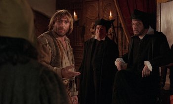 Movie still from “The Return of Martin Guerre” (1982), directed by Daniel Vigne – A group of men standing next to each other in a room; Medium shot, Over the shoulder angle