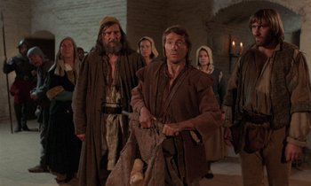 Movie still from “The Return of Martin Guerre” (1982), directed by Daniel Vigne – A group of people standing in a room; Medium shot, Low angle