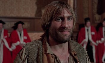 Movie still from “The Return of Martin Guerre” (1982), directed by Daniel Vigne – A person with long brown hair and a beard; Close Up shot, Low angle