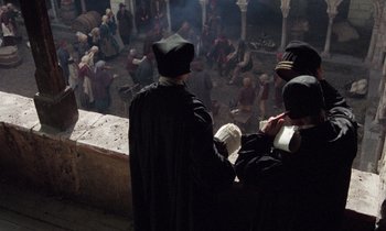 Movie still from “The Return of Martin Guerre” (1982), directed by Daniel Vigne – A group of men in black robes standing next to each other; Wide shot, High angle