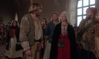 Movie still from “The Return of Martin Guerre” (1982), directed by Daniel Vigne – A group of people standing around in a room; Medium shot, Over the shoulder angle