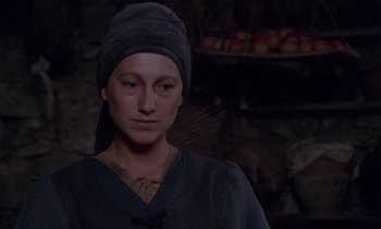 Movie still from “The Return of Martin Guerre” (1982), directed by Daniel Vigne – A woman wearing a medieval clothing and a head covering; Close Up shot, Over the shoulder angle