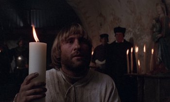 Movie still from “The Return of Martin Guerre” (1982), directed by Daniel Vigne – A man holding a candle in front of a group of people; Close Up shot, Low angle