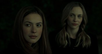 Movie still from “The Ring” (2002), directed by Gore Verbinski – Two young women standing next to each other in the dark; Close Up shot, Low angle