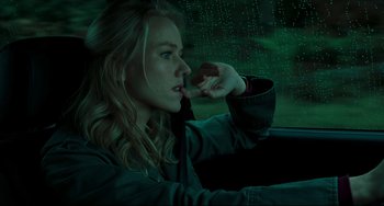 Movie still from “The Ring” (2002), directed by Gore Verbinski – A woman sitting in the driver's seat of a car in the rain; Close Up shot, Low angle