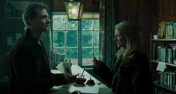 Movie still from “The Ring” (2002), directed by Gore Verbinski – A man and a woman at a table in front of a window; Medium shot, Low angle