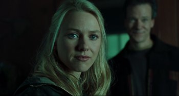 Movie still from “The Ring” (2002), directed by Gore Verbinski – A person wearing a jacket with a man in the background; Close Up shot, Over the shoulder angle