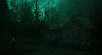 Movie still from “The Ring” (2002), directed by Gore Verbinski – A cabin in the middle of the woods at night; Extreme Wide shot, Low angle