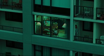 Movie still from “The Ring” (2002), directed by Gore Verbinski – A person sitting at a desk in a room with windows; Extreme Wide shot, High angle