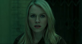 Movie still from “The Ring” (2002), directed by Gore Verbinski – A woman with long blonde hair and blue eyes stares into the camera; Close Up shot, Low angle