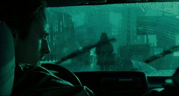 Movie still from “The Ring” (2002), directed by Gore Verbinski – A man driving a car in the rain; Close Up shot, Over the shoulder angle