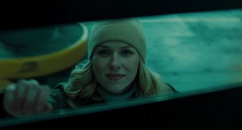 Movie still from “The Ring” (2002), directed by Gore Verbinski – A woman with a hat looking at the camera in the dark; Close Up shot, Over the shoulder angle