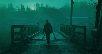 Movie still from “The Ring” (2002), directed by Gore Verbinski – A man walking across a bridge in the fog; Extreme Wide shot, Low angle