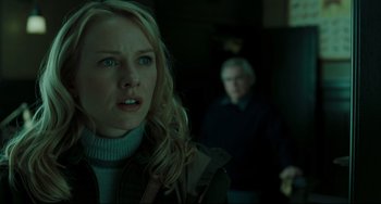 Movie still from “The Ring” (2002), directed by Gore Verbinski – A woman with blonde curly hair and a man in a dark room; Close Up shot, Over the shoulder angle