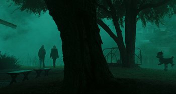Movie still from “The Ring” (2002), directed by Gore Verbinski – Two people walking in a park under a tree; Extreme Wide shot, Low angle