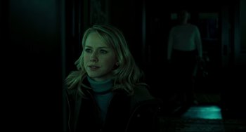 Movie still from “The Ring” (2002), directed by Gore Verbinski – A woman in a dark room looking at the camera; Medium shot, Over the shoulder angle