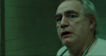Movie still from “The Ring” (2002), directed by Gore Verbinski – An older man looking into the distance in a dark room; Close Up shot, Low angle