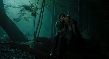 Movie still from “The Ring” (2002), directed by Gore Verbinski – Two people sitting on a bench in the woods at night; Wide shot, Low angle
