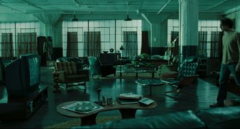 Movie still from “The Ring” (2002), directed by Gore Verbinski – A living room filled with lots of furniture and windows; Wide shot, High angle