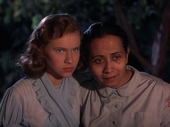 Movie still from “The River” (1951), directed by Jean Renoir – A woman and a young girl posing for a picture; Close Up shot, Low angle