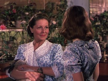 Movie still from “The River” (1951), directed by Jean Renoir – Two women are standing in front of each other; Medium shot, Over the shoulder angle