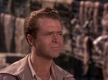 Movie still from “The River” (1951), directed by Jean Renoir – A person wearing a shirt; Close Up shot, Over the shoulder angle