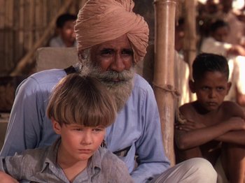 Movie still from “The River” (1951), directed by Jean Renoir – An old man and a young boy are sitting together; Medium shot, Over the shoulder angle