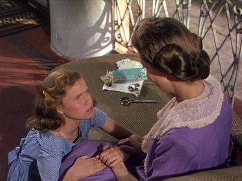 Movie still from “The River” (1951), directed by Jean Renoir – A young girl sitting next to an older woman; Medium shot, High angle